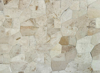 Light beige flagstone or flat paving stone texture tile slabs. Sedimentary flagstone or commonly known as Palimanan stone in Indonesia, is usually cut in irregular shapes used as finishing to walls