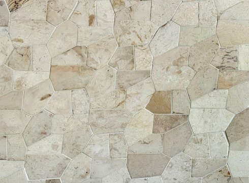Light beige flagstone or flat paving stone texture tile slabs. Sedimentary flagstone or commonly known as Palimanan stone in Indonesia, is usually cut in irregular shapes used as finishing to walls