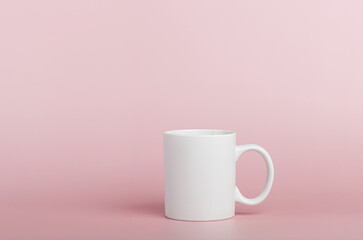 white cup for tea or coffee on a pink background