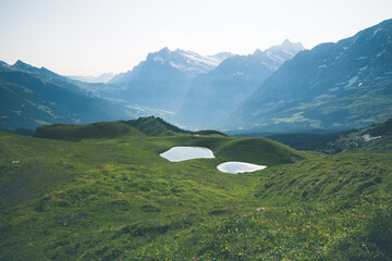 Mannlichen to Kleine Scheidegg hiking trail scenery in Switzerland on a clear summer day
