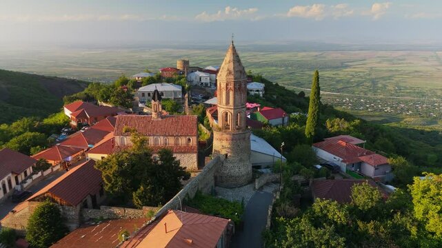 Aerial sunset shot of Cathedral of St. George the Victorious in Signagi, Georgia. Beautiful old Signagi - city of love in Kakheti Region. Alazani Valley in the background