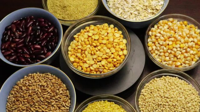 Mung beans rotate in the center. Grain cereals, various legumes, and grains close up 4k footage. Healthy eating, alternative food. 
