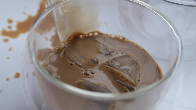 pour coffee carelessly closeup of cup of coffee, tea suddenly spills, hot liquid spilled on the table, floor, concept of bad luck, a hard day, careless handling of dishes, an accident at workplace
