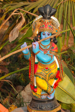 Indian figurine of the god Krishna holding a stick instead of a flute.