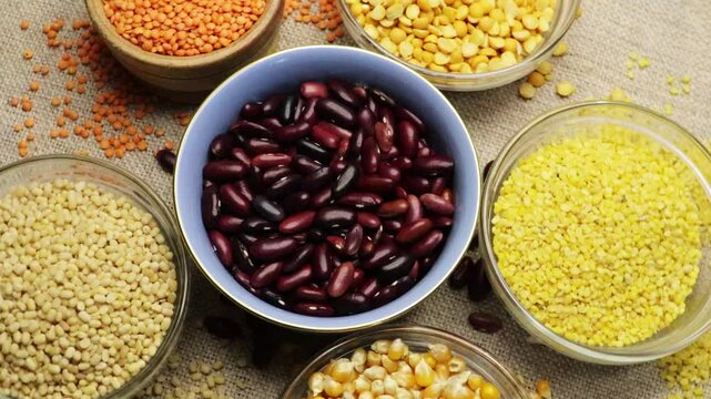 Rajma beans rotate in the center. Grain cereals, various legumes, and grains close up 4k footage. Healthy eating, alternative food.

