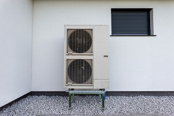 Two efficient outdoor heat pump units placed in front of the house.