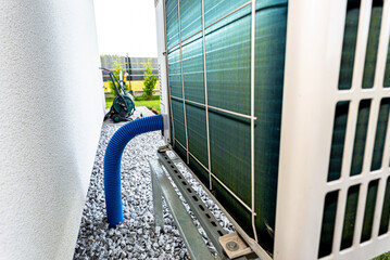 Two efficient outdoor heat pump units placed in front of the house.
