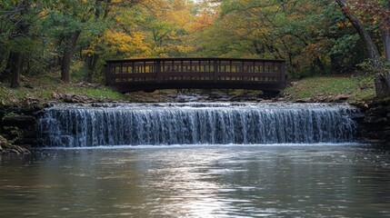 Fototapeta premium Autumn Bridge over Serene Waterfall