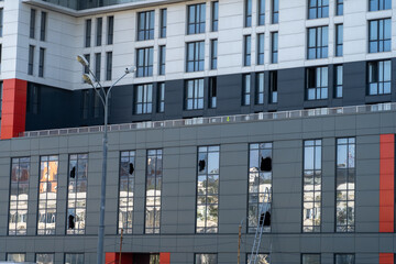 facade of the building has broken windows so that firefighters can climb fire escapes