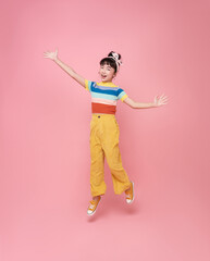 Full length attractive pretty lucky glad cheerful cheery asian girl jumping celebrating great success isolated on pink color background.