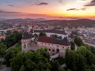 Fototapeta premium Aerial sunset view of Ljubljana castle and city with pentagonal bastion, Archer's tower, courtyard in the Slovenian capital