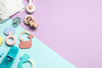 Bright rattles, diaper, bottle and pacifier on color background, flat lay with space for text. Baby...