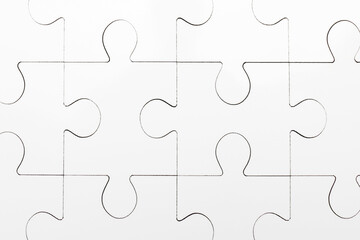 Fototapeta premium White puzzle as background, top view. Intellectual game