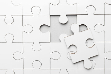 White puzzle with missing piece on grey background, top view