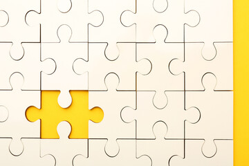 White puzzle with missing piece on yellow background, top view