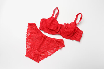 Elegant red lace women's underwear on white background, top view