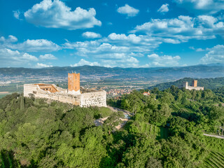Fototapeta premium Aerial view of Romeo and Juliet castles in Montecchio Maggiore, rare pair of mountain fortifications in Italy with square towers functioning theater 