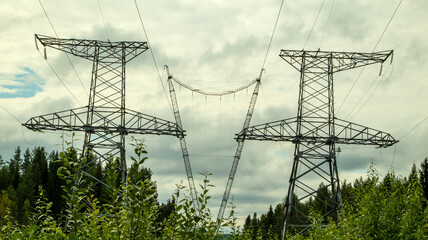 high voltage power lines against a gloomy sky