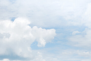 Sky. Blue sky with white clouds background. Curly clouds on a sunny summer day. Light cloudy. Good weather. Simple background sky for summer poster. Summer mock up. Soft focus.