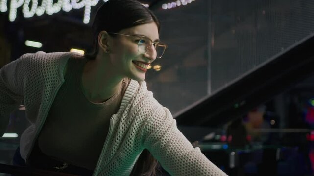 Medium shot of young confident Middle Eastern woman playing billiard game on green table at bar