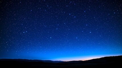 A stunning night sky filled with stars over a serene landscape at twilight.