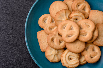 Delicious fresh sweet crispy butter cookies on a dark background
