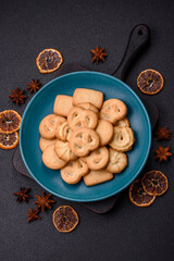 Delicious fresh sweet crispy butter cookies on a dark background