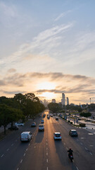 a sunset on a street from a bridge