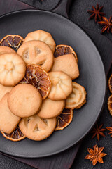 Delicious fresh sweet crispy butter cookies on a dark background