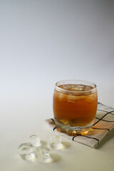 Ice tea with ice cubes on the side, isolated on white background. Iced tea is a refreshing beverage made by brewing tea and then cooling it, typically served over ice.