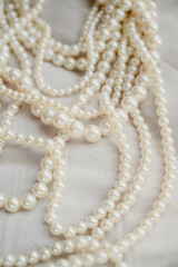 Pearl necklace. Shiny background of jewelry. Royal luxury pearl beads