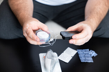 Man changing insulin catheter, insulin pump