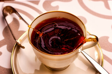 Snapshot of a coffee cup with surface movement and coffee drops