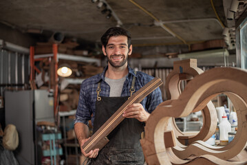 Luthier is working on the neck of a classical guitar