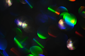 Abstract black background with bokeh of different colors.