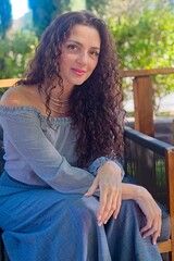 Woman in Gray Outfit Relaxing on a Wooden Deck with Yellow Shoes