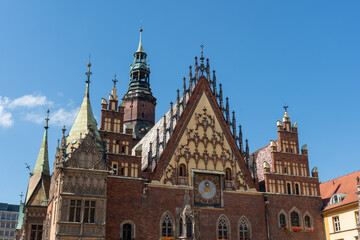 Fototapeta premium Historic gothic architecture of wroclaw town hall under clear blue sky on sunny day. High quality photo