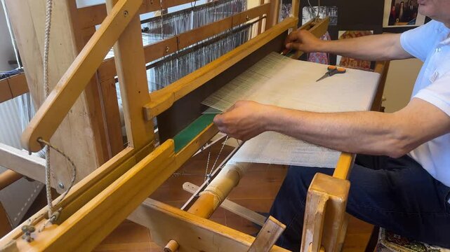Carpet weaving using traditional techniques on a loom. , close-up of weaving and handmade carpet production