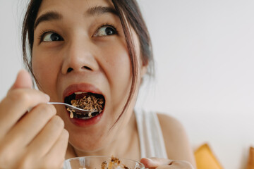 Enjoy face of Asian woman eating dessert made of yogurt. Happy healthy diet.