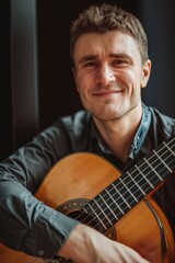 Obraz premium Caucasian musician plays vibrant green guitar with rich brown color and black pickguard in high-end occupational photo. Happy man smiles as he gazes directly into camera, creating intimate atmosphere.