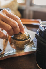 Close up of woman hands making a simple tea.