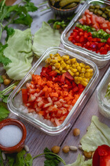 different vegetables cut in a bowl. Colorful shades. cabbage, peppers, onion, corn, tomato, pickle.