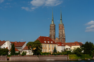 Naklejka premium Towers of the ancient church in the sunset sun on a sunny summer day in Wroclaw, Poland. High quality photo
