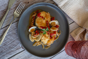 fish dish with clams and homemade sauce 