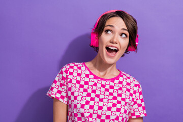 Photo of cute cheerful positive glad girl wear pink trendy clothes buy modern device headphones isolated on purple color background
