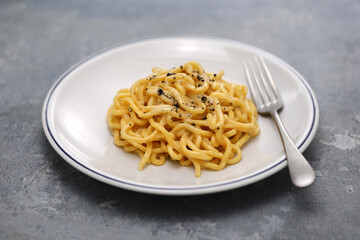 cheese and pepper pasta (tonnarelli cacio e pepe), traditional cuisine of Rome, Italy
