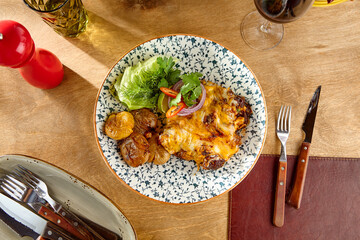 Rustic Beef au Gratin with Potatoes on Elegant Dinner Table - Earthy and Warm Color Palette