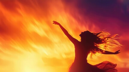 A silhouette of a dancer celebrating freedom against a stunning sunset backdrop, capturing the...