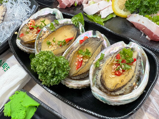 Korean seafood dishes. Grilled abalone shell