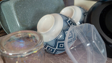 Various dishes after washing. Bowls, plastic containers, baking dish after washing